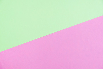 Pastel colored paper flat lay top view, background texture, green and pink
