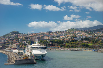 Large luxury white cruise ship at Seaport of Funchal, Madeira Island, Portugal.