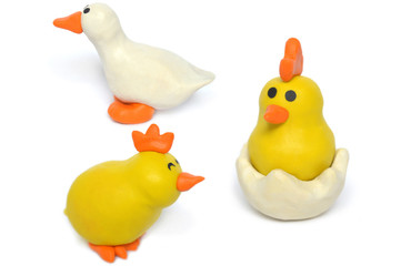 Modelling clay duck and baby chicken on white background