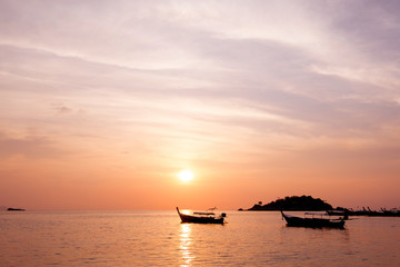 Fototapeta na wymiar Longtail boats on seashore at sunrise in summer time concept travel, holiday and vacation. Tropical paradise beach nature landscape at Lipe island in Thailand.