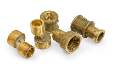 Different brass pipe fittings and plumbing components on white background