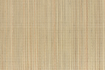 Beige natural mat of dry wicker grass as texture, background.