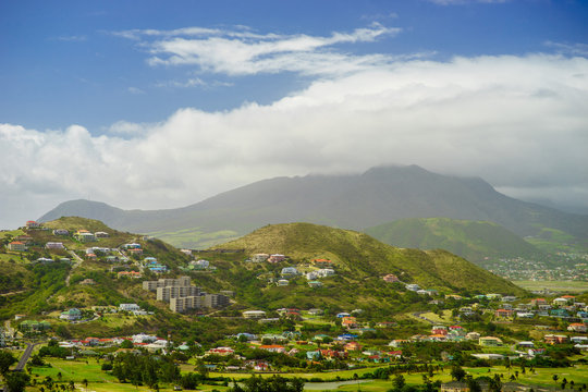 A view over St. Kitts Island with residential area and lush green hills on the background