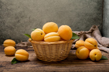 apricots in a basket on wooden table