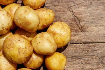New potatoes on rustic wooden table