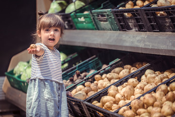 little girl with potatoes in hands