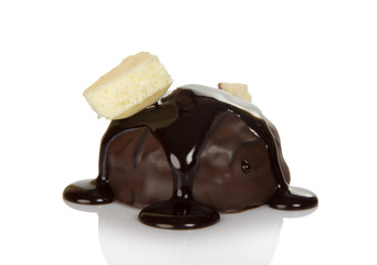 Candy with praline and melted chocolate, piece of white on top, isolated on white