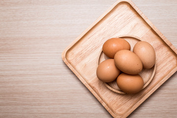 Close-up view of chicken eggs on wooden table background