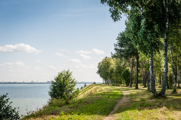 Footpath along Baltic Sea with a view of the city. Tallinn, Estonia.