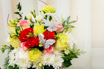 Wedding bouquet of multicolored roses and chamomile. Flowers for holidays and celebrations_