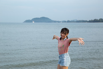 Fototapeta na wymiar Girl smiling at the beach