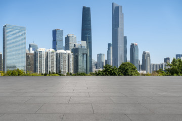 Obraz na płótnie Canvas Urban skyscrapers with empty square floor tiles