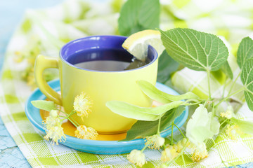 Cup of herbal tea with linden blossoms and lemon