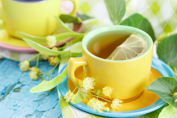 Cups of herbal tea with linden blossoms and lemon