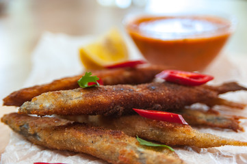 Roasted capelins with lemon and dip sauce 