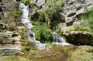 Fototapeta na wymiar Clear water waterfall in zoological park of Tbilisi in Georgia 