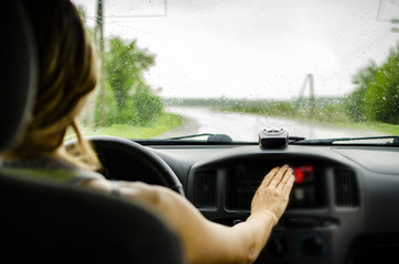 girl driving a car rides along the road