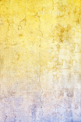 Old stucco wall texture of yellow and blue colors