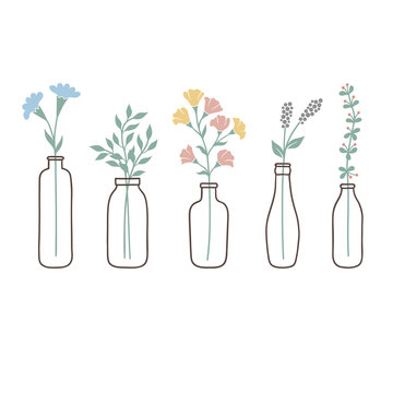 Set of bottles with cute pastel wild flowers and grasses