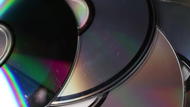 Cd dvd blue ray rotating pattern macro texture background backdrop footage video.
