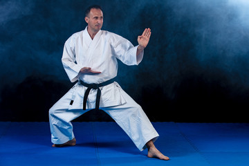 White Karate Fighter Isolated On Black with smoke effect © FS-Stock