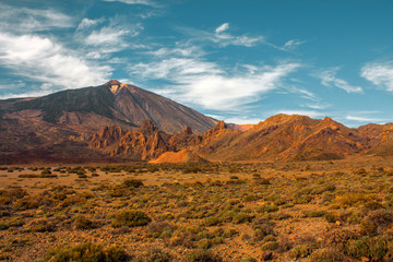 Teide National Park. Beautiful view of volcano mountain rocks desert crater and El Teide, the highest volcano in the Atlantic Ocean Canary islands on a sunny day and blue sky. Tenerife, Canary Islands