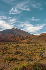 Fototapeta na wymiar Teide National Park. Beautiful view of volcano mountain rocks desert crater and El Teide, the highest volcano in the Atlantic Ocean Canary islands on a sunny day and blue sky. Tenerife, Canary Islands