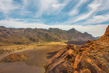 Teide National Park. Beautiful view of volcano mountain rocks desert crater and El Teide, the highest volcano in the Atlantic Ocean Canary islands on a sunny day and blue sky. Tenerife, Canary Islands