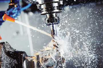 Milling metalworking process. Industrial CNC metal machining by vertical mill. Coolant and...