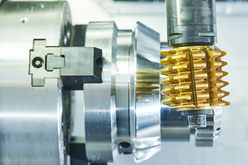 cogwheel milling process. Industrial CNC metal machining by hobbing cutter mill