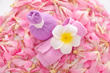Fototapeta na wymiar Many pink tropical petals background with and herbal ball,rolled towel, frangipani ,