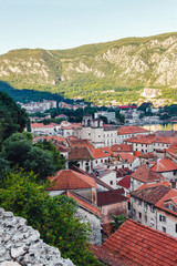 Fototapeta na wymiar View from above on old historical city Kotor, with orange tiling roofs, morning time, Montenegro