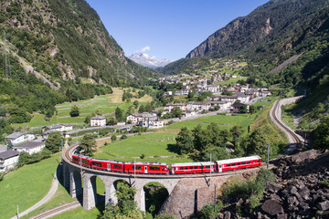 Bernina Express, red train of Bernina over the viaduct of Brusio, Unesco heritage - obrazy, fototapety, plakaty