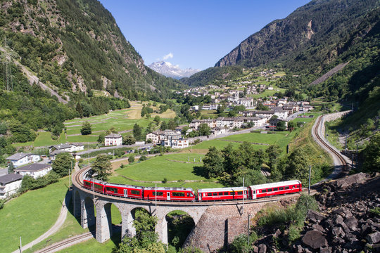 Bernina Express, red train of Bernina over the viaduct of Brusio, Unesco heritage