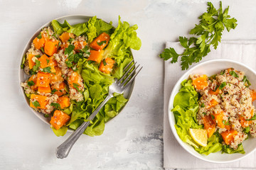 Healthy quinoa salad with roasted pumpkin and greens, top view. Healthy vegan food concept.