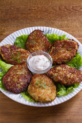 Potato pancakes with sour cream or yogurt. Vegetable fritters, latkes, draniki.