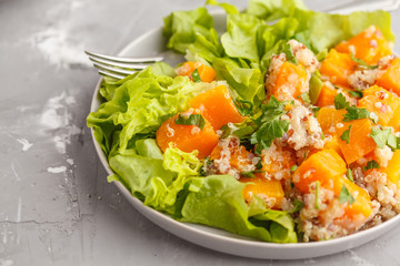 Healthy quinoa salad with roasted pumpkin and greens. Superfood and clean eating concept.