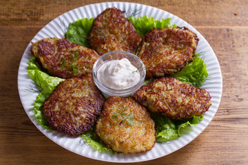 Potato pancakes with sour cream or yogurt. Vegetable fritters, latkes, draniki.