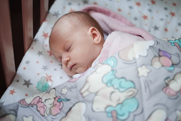 Baby girl sleeping in her bed.