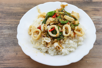 Rice topped with stir-fried squid and basil