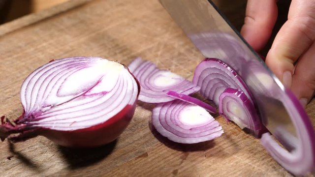 Chef cooking vegetable salad for breakfast slicing the onion