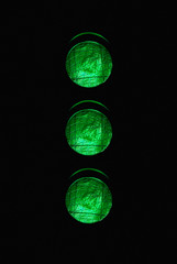 Traffic light with three green lights illuminated