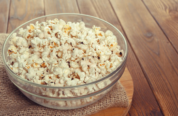 Salt popcorn on the wooden table