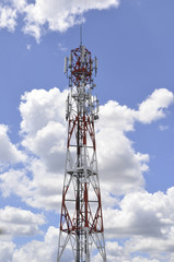 Telecommunications repeater tower against a clear blue sky.