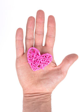Adult male hand holding a small heart isolated