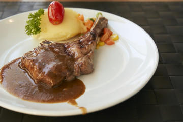 Roasted Lamb Chops on barbecue sauce with mash potato and salad.