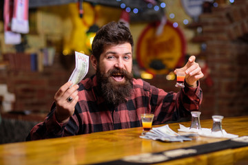 Guy spend leisure in bar drinking cocktail, defocused background.