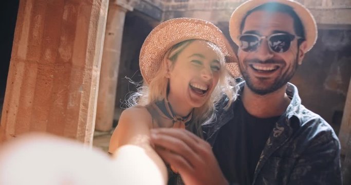 Young couple having fun taking selfies at Greek classical monument