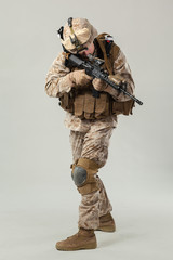 Soldier in camouflage holding rifle