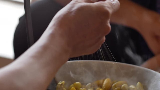 Boiling yellow silkworm cocoons by boiler to make silk thread.